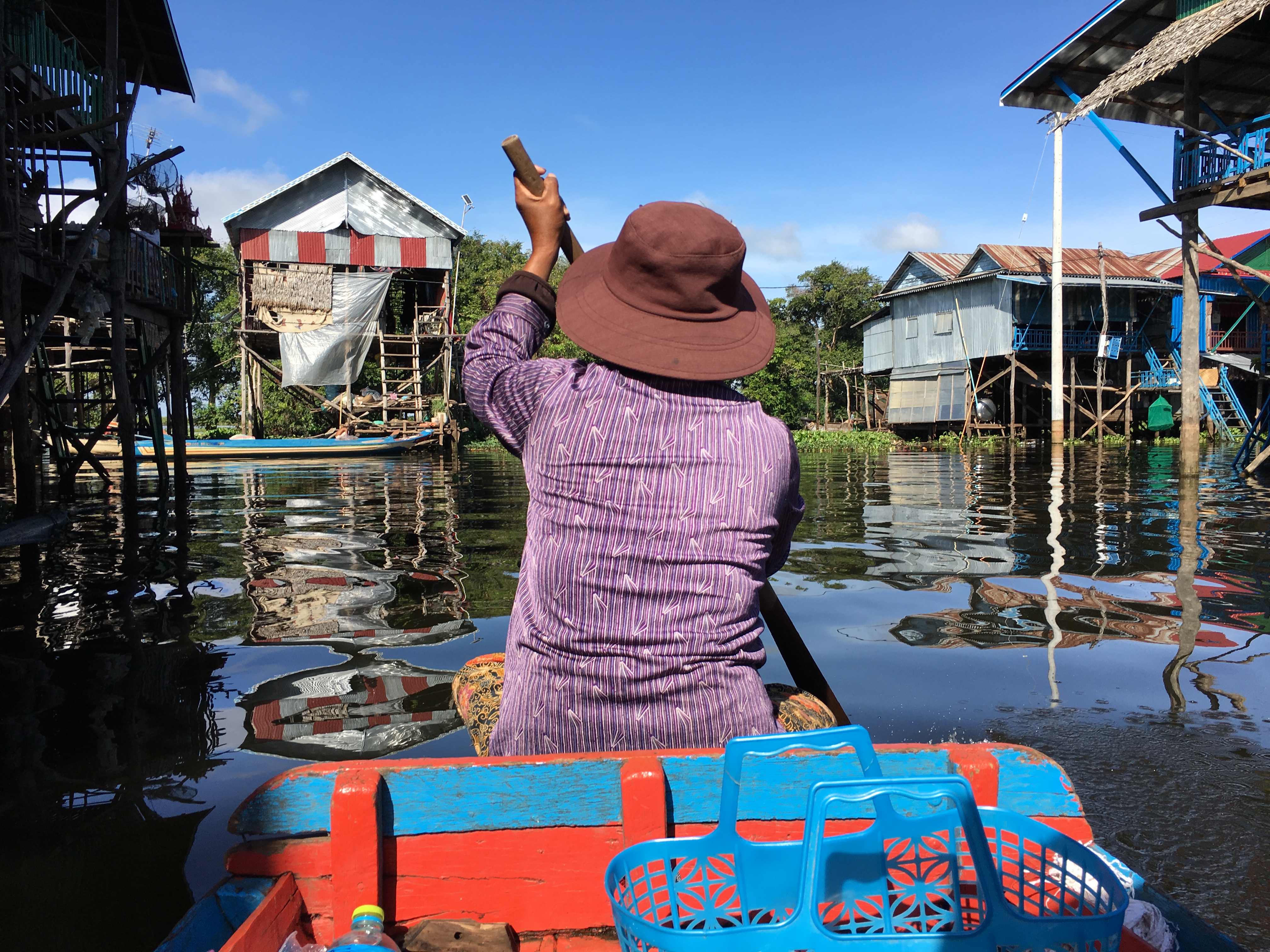 Woman Paddling Boat on Tonle Sap Lake Cambodia