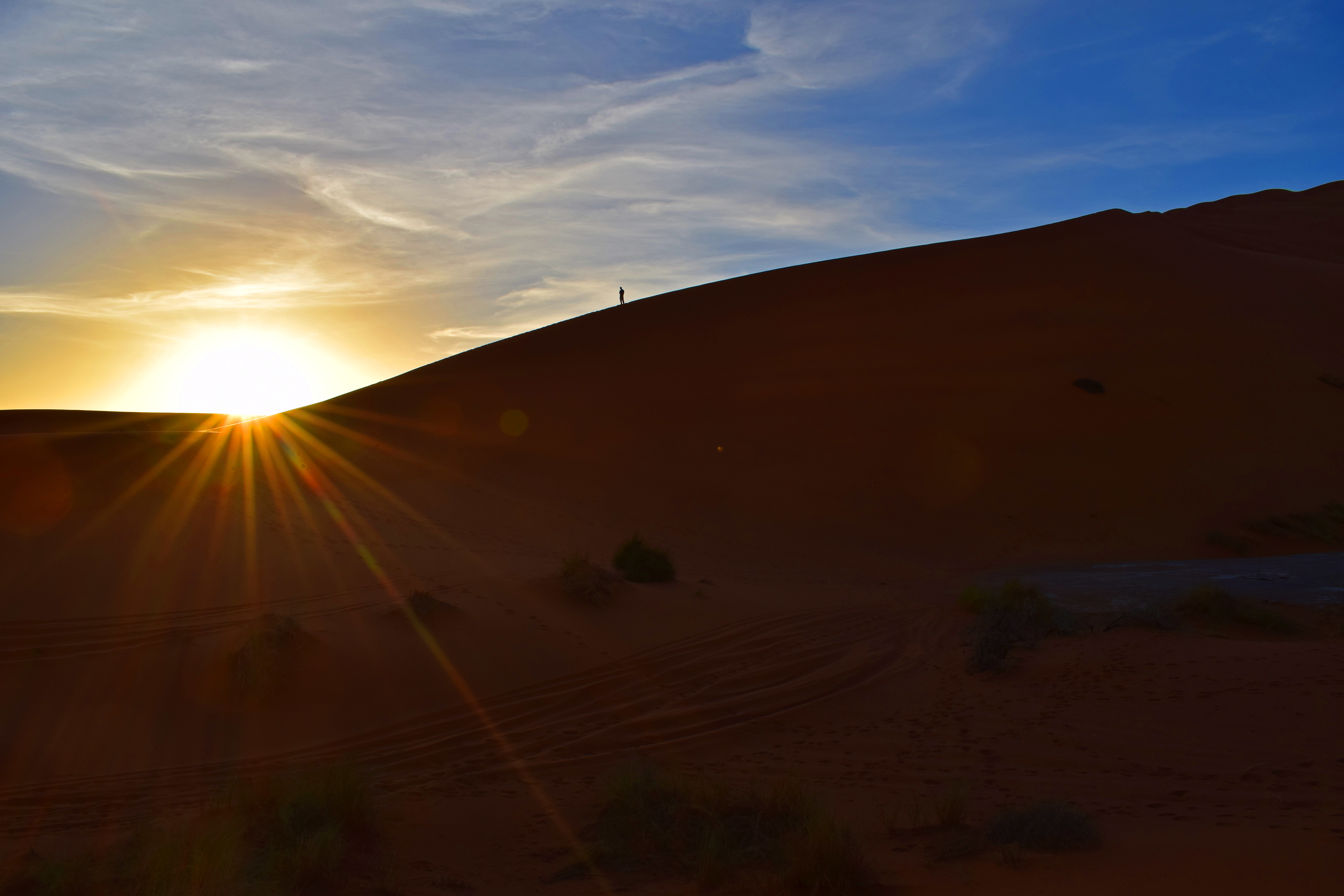 Man on top of Sand Dune in Sahara Desert Morocco